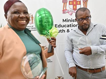 Acting principal Beverley Feare and Haniff Nembhard, mathematics teacher at Maud McLeod High School, with their awards at the Tactical Approach Awards 2025 for excellence, in recognition of being among the top 20 teachers from high schools with the highest