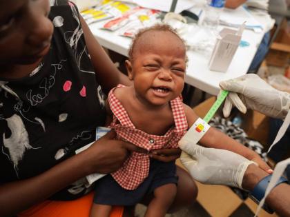A malnourished child is checked on by a doctor from a travelling pharmacy at a shelter for families displaced by gang violence in Port-au-Prince, Haiti, Tuesday, October 7, 2025. (AP Photo/Patrice Noel)