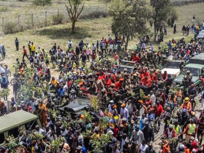 Mourners gather for the arrival of the body of Kenya's former Prime Minister Raila Odinga arrives in Nairobi, Kenya, a day after he died in India, Thursday, October 16, 2025. (AP Photo/Samson Otieno)