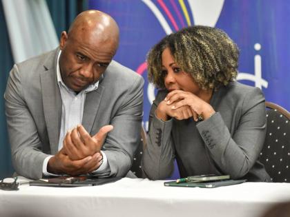 Dr Adrian Stokes (left), chairman of the Education Transformation Oversight Committee, and Education Minister Dr Dana Morris Dixon in conversation at an ETOC press conference yesterday.