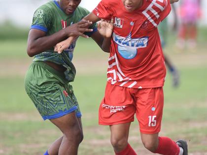 Jovan Russell (left) of Norman Manley High and Campion College’s Luke Stanley battle for the ball during their Manning Cup football match at Campion yesterday.