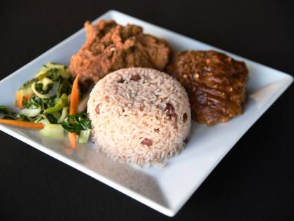 Rice and peas with fried chicken and steamed vegetables.