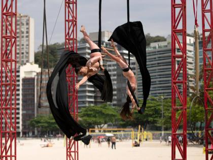 Members of the aerial circus group Pendurados perform in an open-air show that explores healing from sexual violence through art and community, at Icarai Beach in Niteroi, Rio de Janeiro.