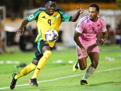 Jamaica’s Kaheim Dixon (left) dribbles by Bermuda’s Lejaun Simmons during their Concacaf World Cup Qualifier on October 14. 