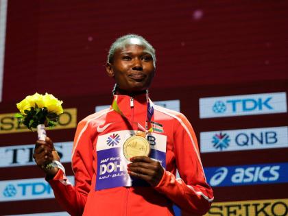 Kenya's Ruth Chepng'etich poses with her gold medal during the medal ceremony for the women's marathon at the World Athletics Championships in Doha, Qatar, September 28, 2019. (AP Photo/Nariman El-Mofty, file)