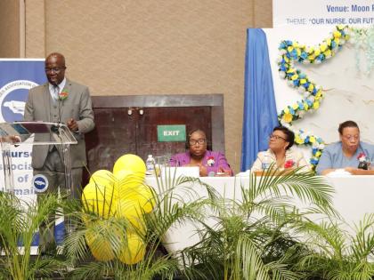 Delroy Williams (left), principal of Iona High, delivers the keynote address at the Nurses Association of Jamaica’s (NAJ’s) 55th Island Conference at the Moon Palace Hotel in Ocho Rios, St Ann, recently. Listening on are (from left): Dawn Marie Richard