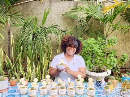 Shara Williams-Lue is all smiles as she poses with one of her potted babies from her Cacti Corner.
