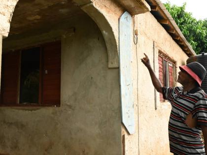 Micah Williams, tomato farmer from Flagaman in St Elizabeth, shows items used to shield him at his home during Hurricane Beryl in 2024.