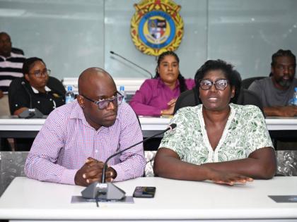 Inspector of Poor for St James, Pauline Lecky, addressing the Emergency Operations Centre (EOC) meeting at the St James Municipal Corporation on Thursday, October 23. Looking on is Public Assistance Division (PAD) Administrator at the Ministry of Labour an