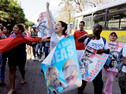 In this 2009 photo students are seen holding posters of Raul Castro and Fidel Castro, and chanting slogans during a march to mark the 48th anniversary of the triumph of Cuban forces during the 1961 Bay of Pigs invasion, in Havana.