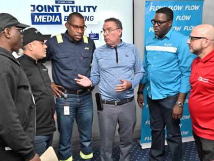 Officials of the Jamaica Public Service, Digicel, Flow, National Water Commission, and National Works Agency at a joint news conference on Hurricane Melissa on October 26, 2025. 