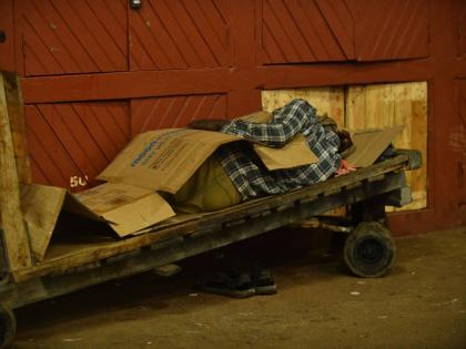 Higglers and hustlers find their areas to sleep in the safety of the Coronation Market as Hurricane Melissa approaches the island yesterday.