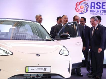 Chinese Premier Li Qiang (right) reacts as he, along with Malaysian Prime Minister Anwar Ibrahim (centre) inspects a car produced by Malaysia’s national automaker, Proton, in which China’s Zhejiang Geely Holding Group holds a 49.9 per cent stake, ahead