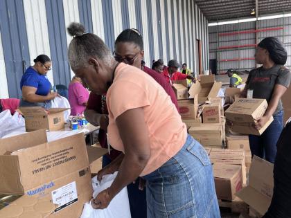 Volunteers prepare relief packages for communities amid Hurricane Melissa.