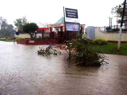 Floodwaters cover a section of Caledonia Avenue in Mandeville, blocking access to the entrance of the Mandeville Regional Hospital after Hurricane Melissa on Tuesday.