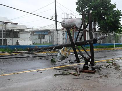 A downed power pole in the vicinity of the Bustamante Hospital for Children on Arthur Wint Drive in St Andrew yesterday.