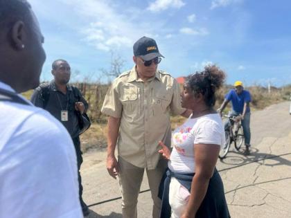 Prime Minister Dr Andrew Holness speaks with a resident during a tour of sections of St Elizabeth on Wednesday.