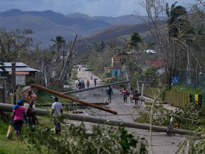 Residents walk through Lacovia Tombstone, Jamaica, in the aftermath of Hurricane Melissa.