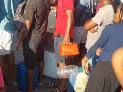 A long line of frustrated persons at a gas station in Savanna-La-Mar, Westmoreland.