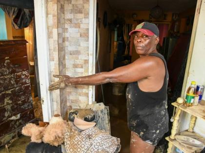 Rose Holness shows the damage to her home in St James. 