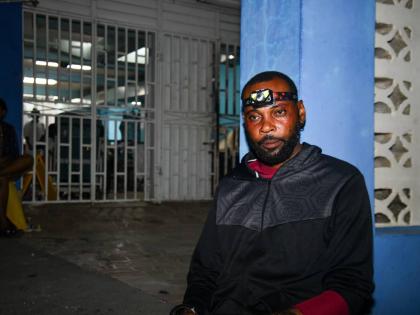 
Mortician Dywite Spence, a worker at Doyley’s Funeral Service, takes a break at 3 a.m. on Thursday at the Savanna-la-Mar Public General Hospital in Westmoreland after spending the last 10 hours retrieving the bodies of hurricane victims across the paris