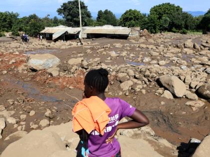 People inspect the scene of a landslide that killed scores in the hilly area of Chesongoch in Elgeyo Marakwet county, western Kenya, Sunday, November 2, 2025. (AP Photo/Andrew Kasuku)