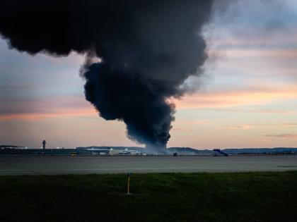 A plume of smoke rises from the site of a UPS cargo plane crash at Louisville Muhammad Ali International Airport on Tuesday, November 4, 2025, in Louisville, Ky. (AP Photo/Jon Cherry)