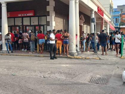Dozens queue up for cash at Scotiabank ATM in Sam Sharpe Square, Montego Bay, the tourism capital of the island. 
