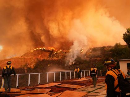 Fire crews monitor the Palisades Fire in Mandeville Canyon on January 11, 2025, in Los Angeles.