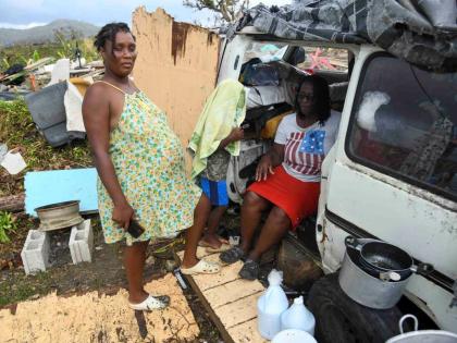 Crystal Morris stands outside the cramped minivan where she shelters with her mom, son and two other relatives in New Works, Westmoreland.