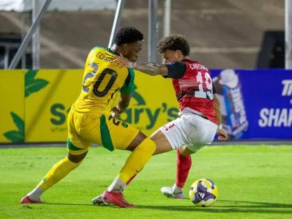 Renaldo Cephas (left) scored for Jamaica in last night’s match against hosts Trinidad and Tobago in their Concacaf World Cup qualifying match. 