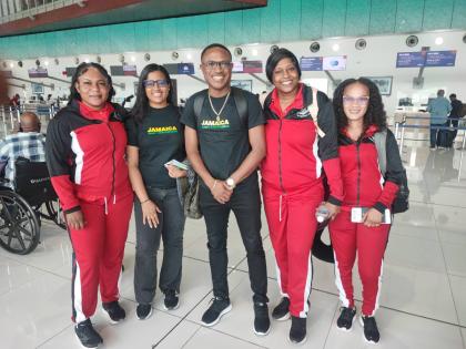 Assistant Commissioner Christopher Phillips (centre), general manager, Police National Netball Team, is joined by (from left) Andrea Roberts, Nichole Lord (team nurse), Keneisha Beckett, and Coletta Leslie ahead of the team’s departure from Jamaica.