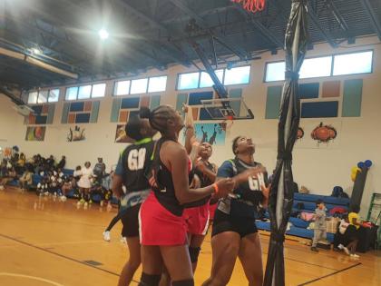 Jamaica's Police National Netball team's goal attack, Marcella Thompson (nearest), watches as goal shoot Kenesha Beckett (partially hidden) scores against Tampa Bay during their second game at the Florida United Netball Extravaganza at the Miramar Youth En