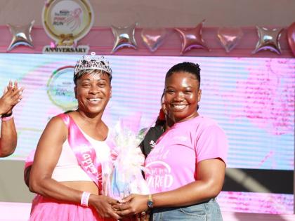 A happy Marlene Dawson (left) receives a gift from Daniela Fagon, finance professional, at the 25th anniversary staging of Jamaica Reach to Recovery’s 5K Pink Run on Sunday at Emancipation Park in New Kingston.