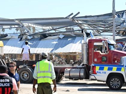 The police in St Elizabeth overlook recovery efforts in Black River in the aftermath of Hurricane Melissa.