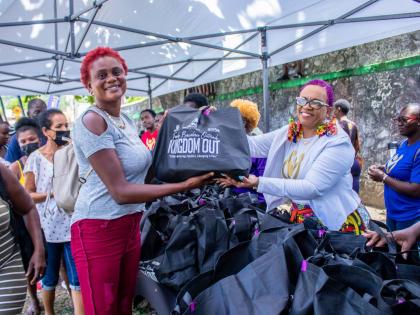 Bishop Dr Carla Dunbar, chief executive officer at Carla Dunbar Ministries International (right), distributing care packages to residents of Portland, at the organisation’s first Kingdom Out stop in 2022 at Lynch Park, Buff Bay, Portland. 