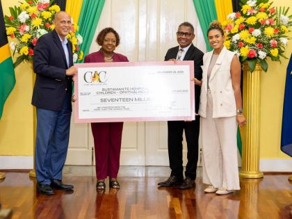 From left: Eric Hosin, chairman of the Come Alive Collective, and Olivia ‘Babsy’ Grange, minister of culture, gender, entertainment and sport, present the symbolic cheque to Anthony Wood, chief executive officer of the Bustamante Hospital for Children,
