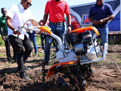Minister of Agriculture, Fisheries and Mining, Floyd Green (left), uses one of the newly acquired walk behind tractors to plough land during a handover ceremony of walk behind tractors and earth augers on November 26, 2025 at the Amity Hall Agro Park in St