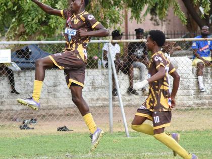 Charlie Smith’s Anthony Bryan (left) and Kevin Howell celebrate the former’s opening goal against St Catherine High during their Manning Cup football match at St George’s College yesterday. Charlie Smith won 4-1.