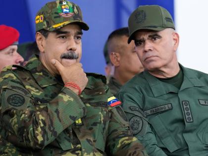 Venezuelan President Nicolas Maduro (left) listens to Defense Minister Vladimir Padrino López during a government-organised civic-military march in Caracas.