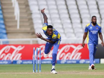 Barbados Pride bowler Dominic Drakes bowls under the watchful eyes of his captain Kyle Mayers during the final of the CGI Super50 against the Trinidad and Tobago Red Force at the Brian Lara Cricket Academy in Couva on Saturday.
