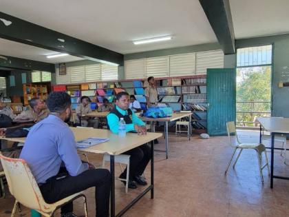 Michael McPherson (right) speaks with mentors and mentees at Calabar High School.