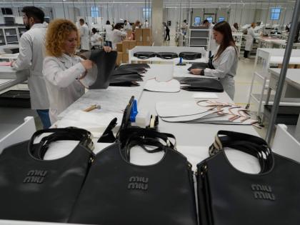 Leather good operators work at the Prada factory in Scandicci, Italy, on Friday, November 28, 2025.