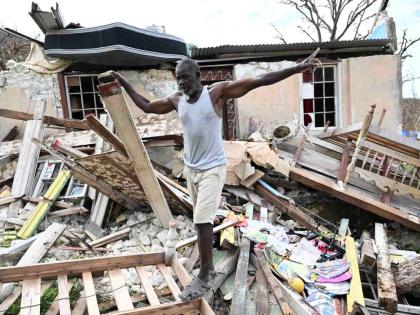 Glenroy Brown stands on the rubble left of a section of his home in Beeston Spring after Hurricane Melissa.