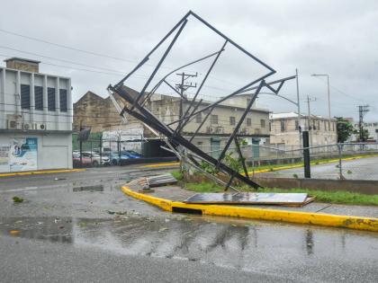 In the midst of Hurricane Melissa, a broken billboard stand is seen at the intersection of Port Royal Street and Ocean Boulevard in Kingston, on October 28, 2025.