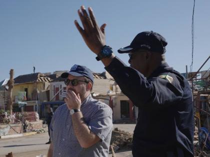UK Minister for the Caribbean, Chris Elmore (left) surveys the devastation in Black River, with head of the St Elizabeth Police Division, Superintendent Coleridge Minto.