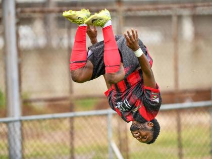 Matthew McKoy/Photographer 
Rushike Kelson of Arnett Gardens FC somersaults as he celebrates scoring a goal.
