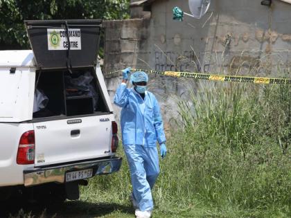 Forensic personnel is seen at a scene where bodies of the victims of a mass shooting where found at a bar near Pretoria, South Africa, Saturday, December 6, 2025. (AP Photo)