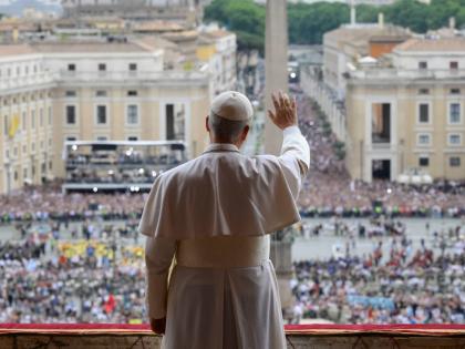 Pope Leo XIV waives from the central balcony of St. Peter's Basilica overlooking St. Peter's Square where tens of thousands of faithful gathered at noon to receive the first traditional Sunday blessing after his election and to pray the Regina Caeli.