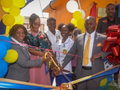 Technical support officer at the Ministry of Education, Skills, Youth and Information, Dr Nahema Daniels Heath (second left), cuts the ribbon to open a smart greenhouse at the José Martí Technical High School in St Catherine on December 5. Joining her (f